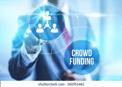 Businessman pointing towards camera selecting crowdfunding , virtual interface