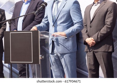 Businessman or politician is giving a speech. Political rally. - Powered by Shutterstock