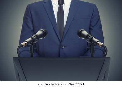 Businessman or politician making speech from behind the pulpit - Shutterstock ID 526422091