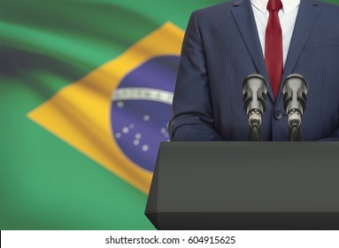 Businessman or politician making speech from behind the pulpit with national flag on background - Brazil - Shutterstock ID 604915625