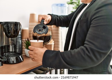 Businessman Pouring Coffee At The Office.