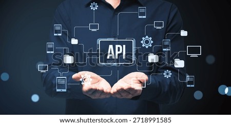 Businessman presenting API interface with connected icons representing software, app, and online network structure on abstract dark background