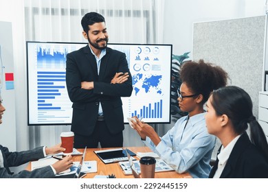 Businessman presenting data analysis dashboard display on TV screen in modern meeting for marketing strategy. Business presentation with group of business people in conference room. Concord - Shutterstock ID 2292445159