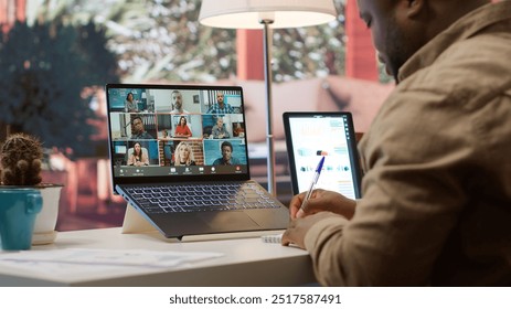 Businessman presents annual sales reports to the shareholders on videocall, working from home to increase funding. Entrepreneur making a development presentation for the investors. Camera A. - Powered by Shutterstock