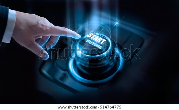 Businessman press start future button with\
virtual light in dark\
background