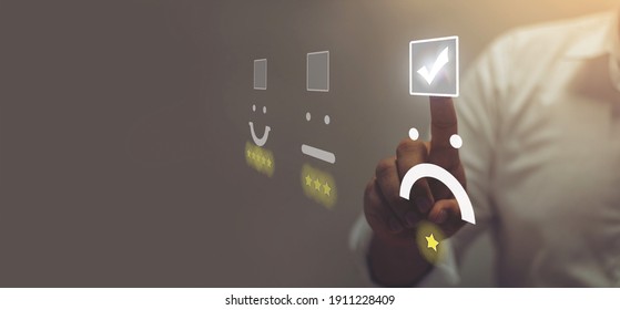 Businessman pressing angry face emoticon on virtual touch screen. Customer service evaluation concept.
