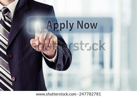 Businessman pressing Apply Now button at his office. Toned photo.