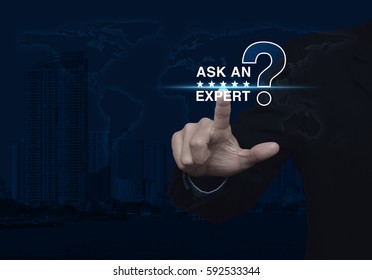 Businessman pressing ask an expert with star and question mark sign icon over world map and modern city tower, Elements of this image furnished by NASA