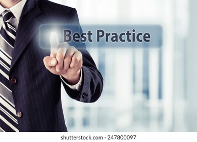 Businessman Pressing Best Practice Button At His Office. Toned Photo.