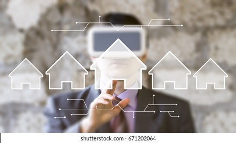 Businessman pressing button house home virtual reality - Powered by Shutterstock