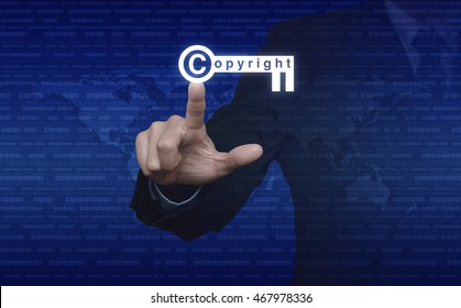 Businessman pressing copyright key icon over digital world map and binary code, Copyright and patents concept, Elements of this image furnished by NASA