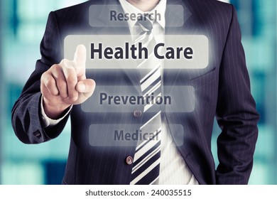 Businessman Pressing Health Care Button. Health Care Concept, Toned Photo.