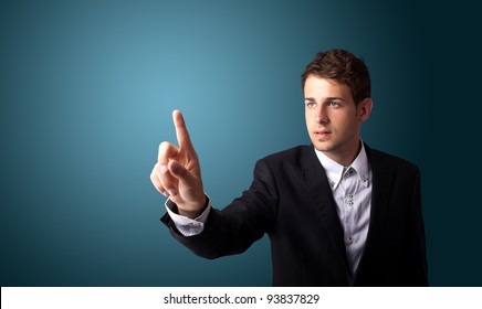 Businessman pressing an imaginary button on bokeh - Powered by Shutterstock