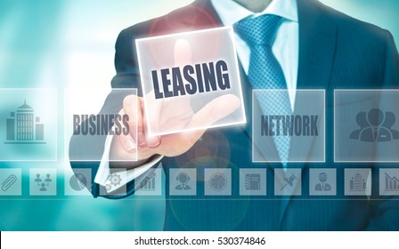 A businessman pressing a Leasing button on a transparent screen.