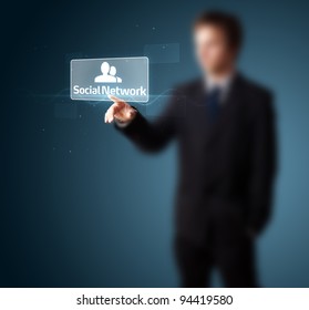 Businessman pressing modern social buttons on a virtual background - Shutterstock ID 94419580