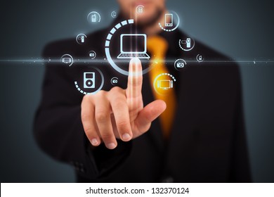 Businessman pressing multimedia type of modern buttons with virtual background - Powered by Shutterstock