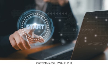 A businessman is pressing start button while using laptop computer. Concept of starting new project, beginning new business or startup entrepreneur.