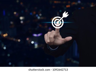 Businessman pressing target with dart icon over blur colorful night light city tower, Business success concept - Shutterstock ID 1092642713