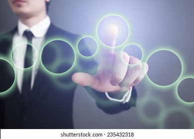 Businessman pressing touch screen interface. selects the circle