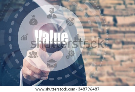 Businessman pressing a Value concept button.