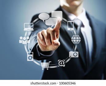 Businessman pressing virtual icons - Powered by Shutterstock