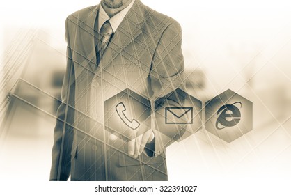 Businessman pressing virtual phone buttons. customer support concept.