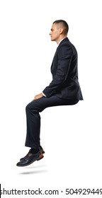 A Businessman In Profile In Sitting Position Isolated On The White Background. Business And Management. Poses And Gestures.