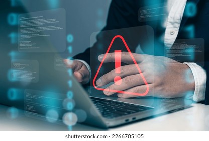 Businessman or programmer using laptop with triangle caution warning sign, coding, cryptography, hacker, crime, virus, for notification error and maintenance concept. - Shutterstock ID 2266705105