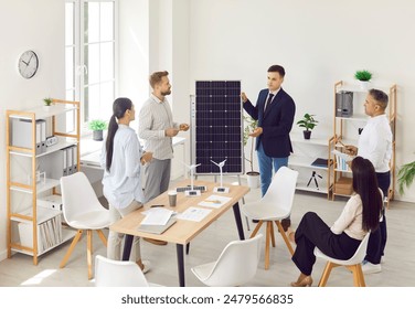 Businessman providing a consultation on solar panels for a team of coworkers or customers during a meeting in the office. Discussing renewable energy and benefits of solar technology. - Powered by Shutterstock