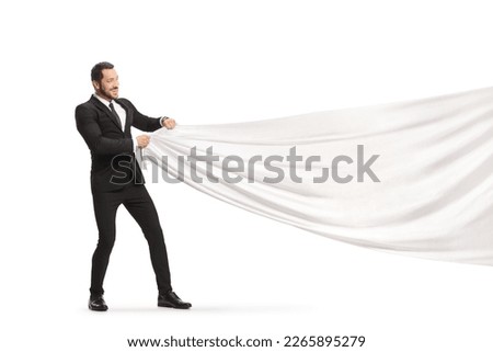 Businessman pulling a big white cloth isolated on white background