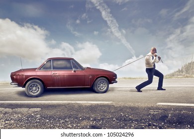 Businessman Pulling An Old Car