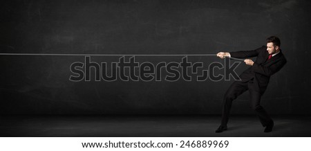 Businessman pulling rope on grey background concept