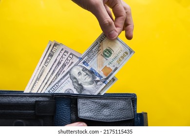 Businessman Pulls Dollars From The Wallet. Concept Showing Investing In The US And Rising Inflation