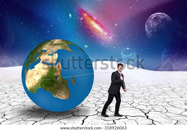 Businessman pulls world sphere in
cosmos desert .Elements of this image furnished by
NASA