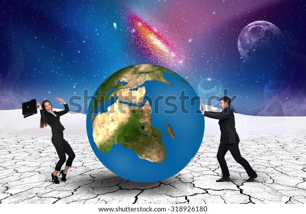 Businessman pushes world sphere in\
cosmos desert .Elements of this image furnished by\
NASA