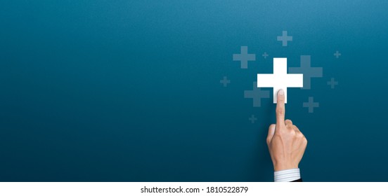 Businessman pushing button positive thing. Business for Profit, Benefit, health insurance, Development and growth concepts. Represented by a plus sign with copy space - Shutterstock ID 1810522879
