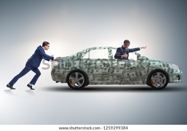 Businessman pushing car\
in business concept