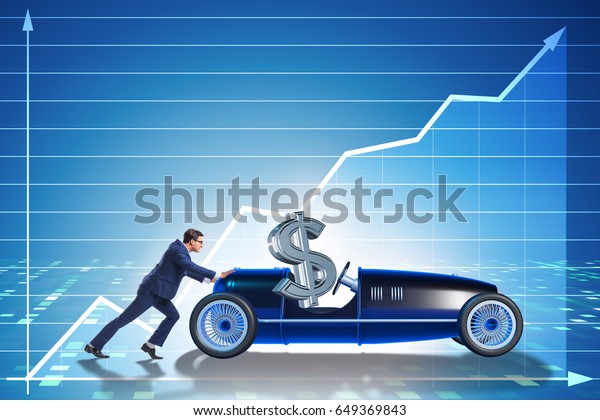 Businessman\
pushing car with dollar in driving\
seat