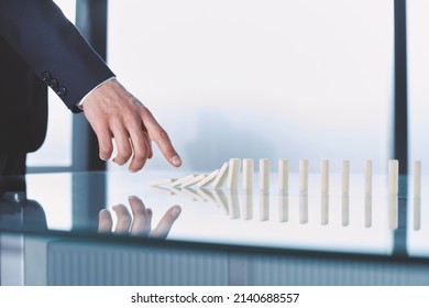 Businessman Pushing Dominoes Standing In A Row.