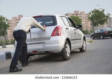 Businessman Pushing His Car