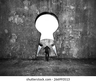 Businessman pushing keyhole door with city buildings view on mottled concrete wall background