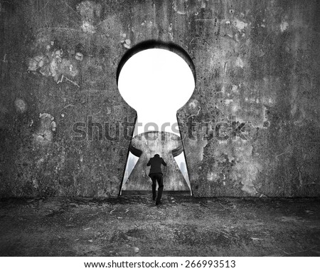 Businessman pushing keyhole door with city buildings view on mottled concrete wall background