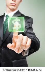 Businessman pushing virtual button with dollar sign.