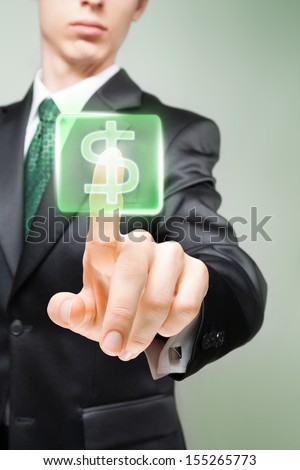 Businessman pushing virtual button with dollar sign.