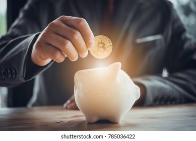Businessman Put Bitcoin To Piggy Bank, Bit Coin BTC The New Virtual Electronic Money, Investment Concept