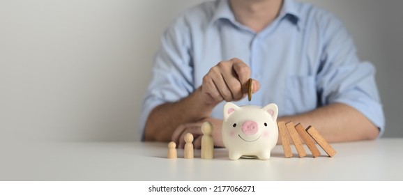 Businessman Put Money Coin In Piggybank To Protect Family From Financial Crisis , Insurance, Donation, Saving, Charity, Family Finance Plan Concept, Fundraising, Financial Crisis Concept