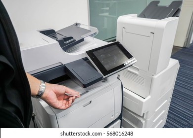 businessman put printed documents from office printer