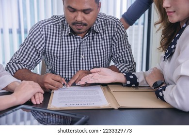 Businessman puts signature on contract at business meeting after negotiations with business partners. Selected focus - Shutterstock ID 2233329773