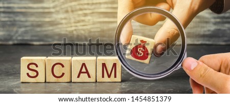 Businessman puts wooden blocks with the word Scam. Fraudulent investment project. Illegal plan to get money. Cheating people. Raw deal. Financial Pyramide. Hacker attack
