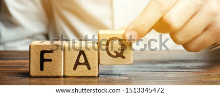 Businessman puts wooden blocks with the word FAQ (frequently asked questions). Collection of frequently asked questions on any topic and answers to them. Instructions and rules on Internet sites